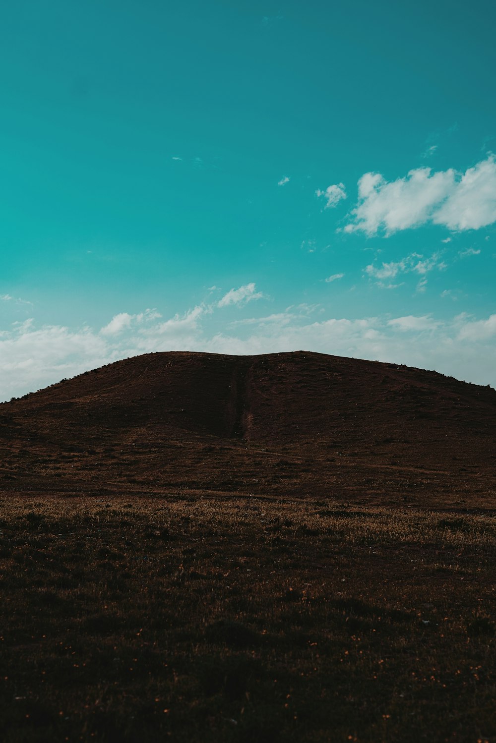 brown mountain under blue sky during daytime