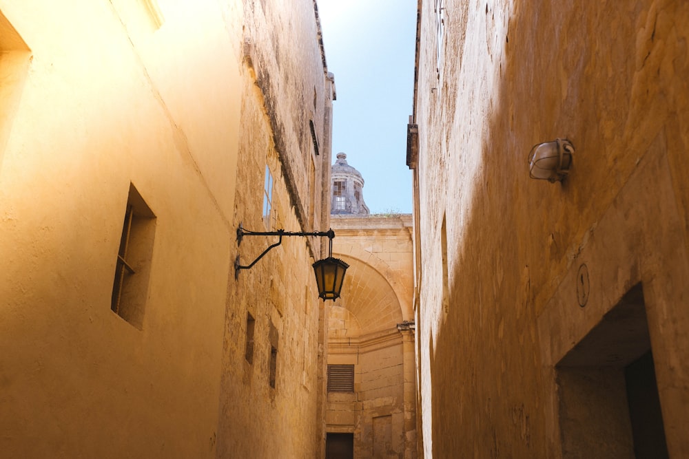 black sconce lamp on brown concrete building during daytime