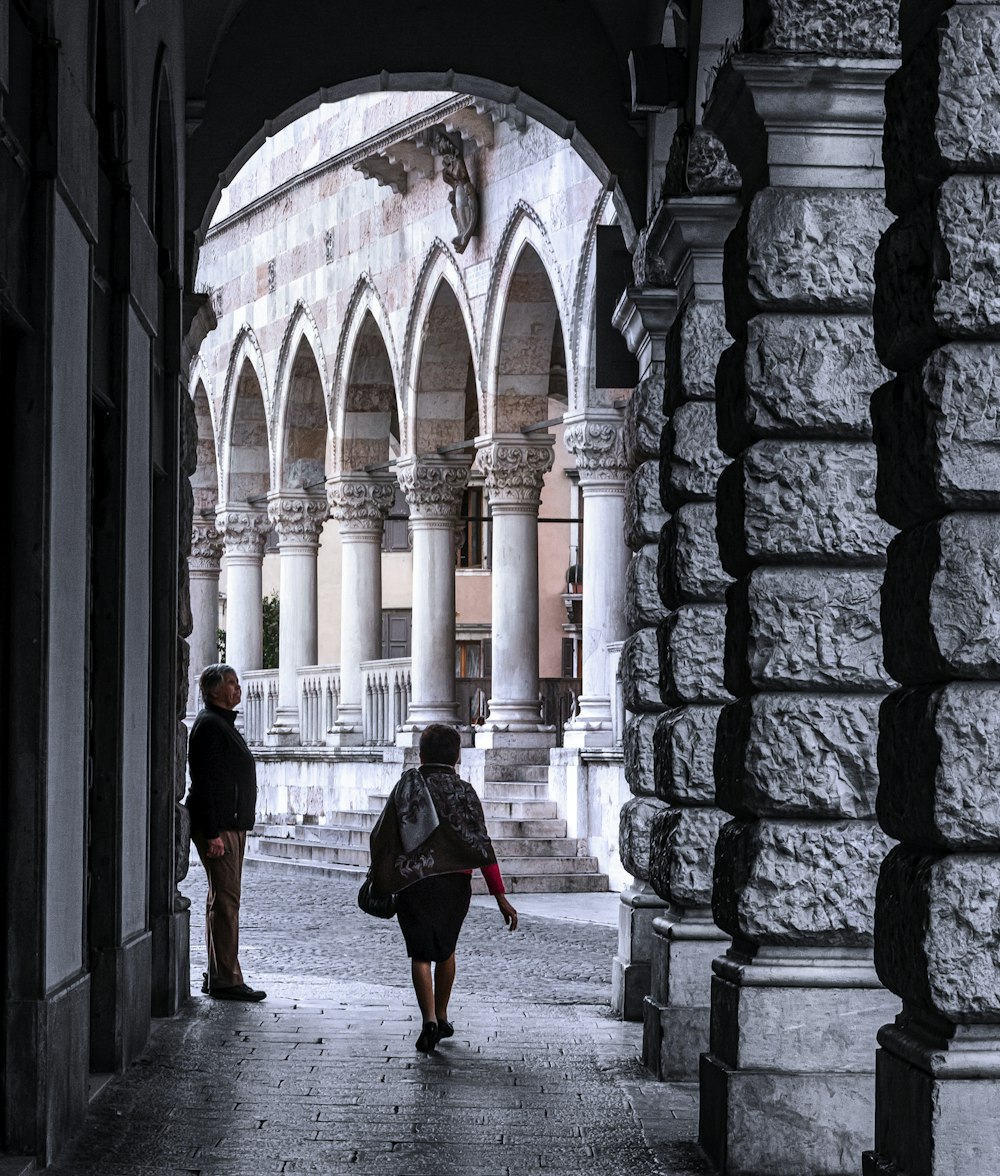 woman in black dress walking on hallway