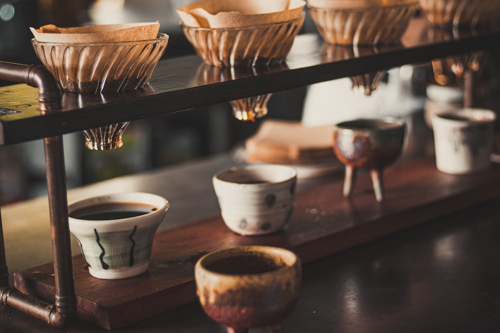 white ceramic bowls on brown wooden rack