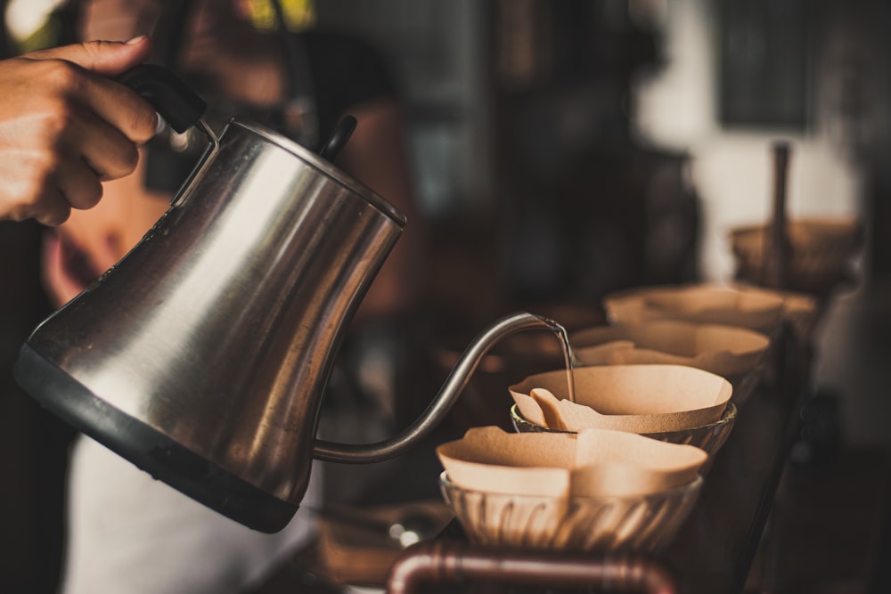 stainless steel cup on brown wooden table