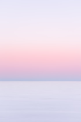 white and pink sky over the sea