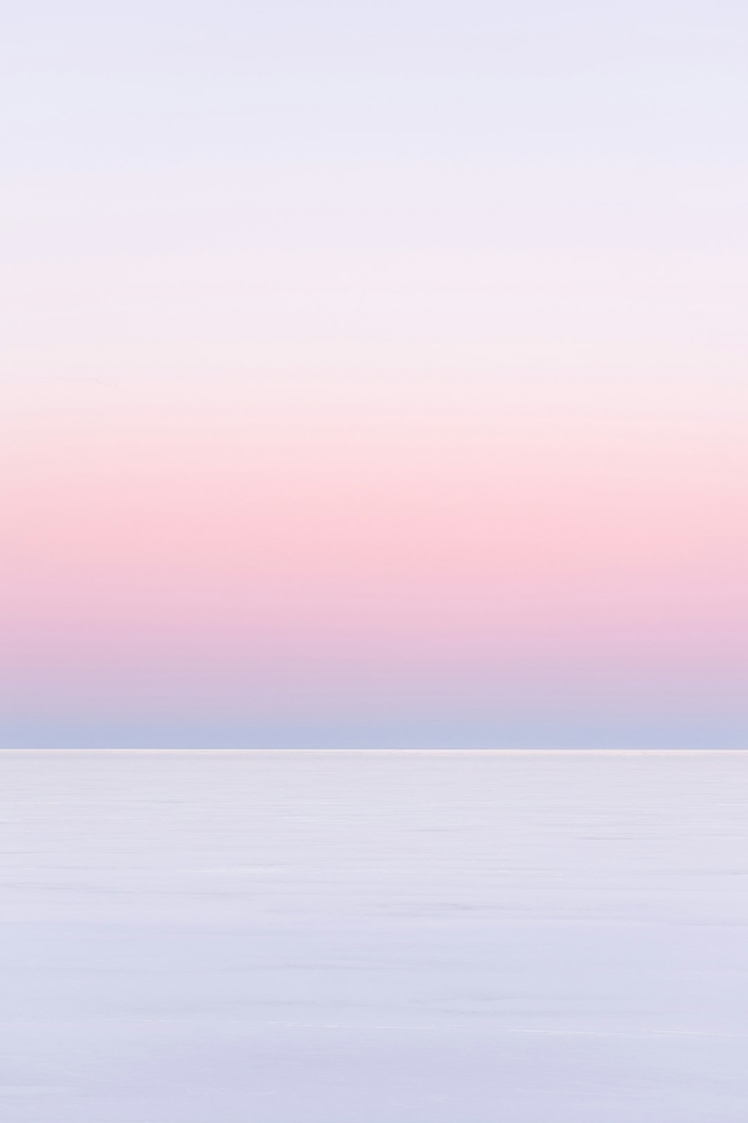 white and pink sky over the sea