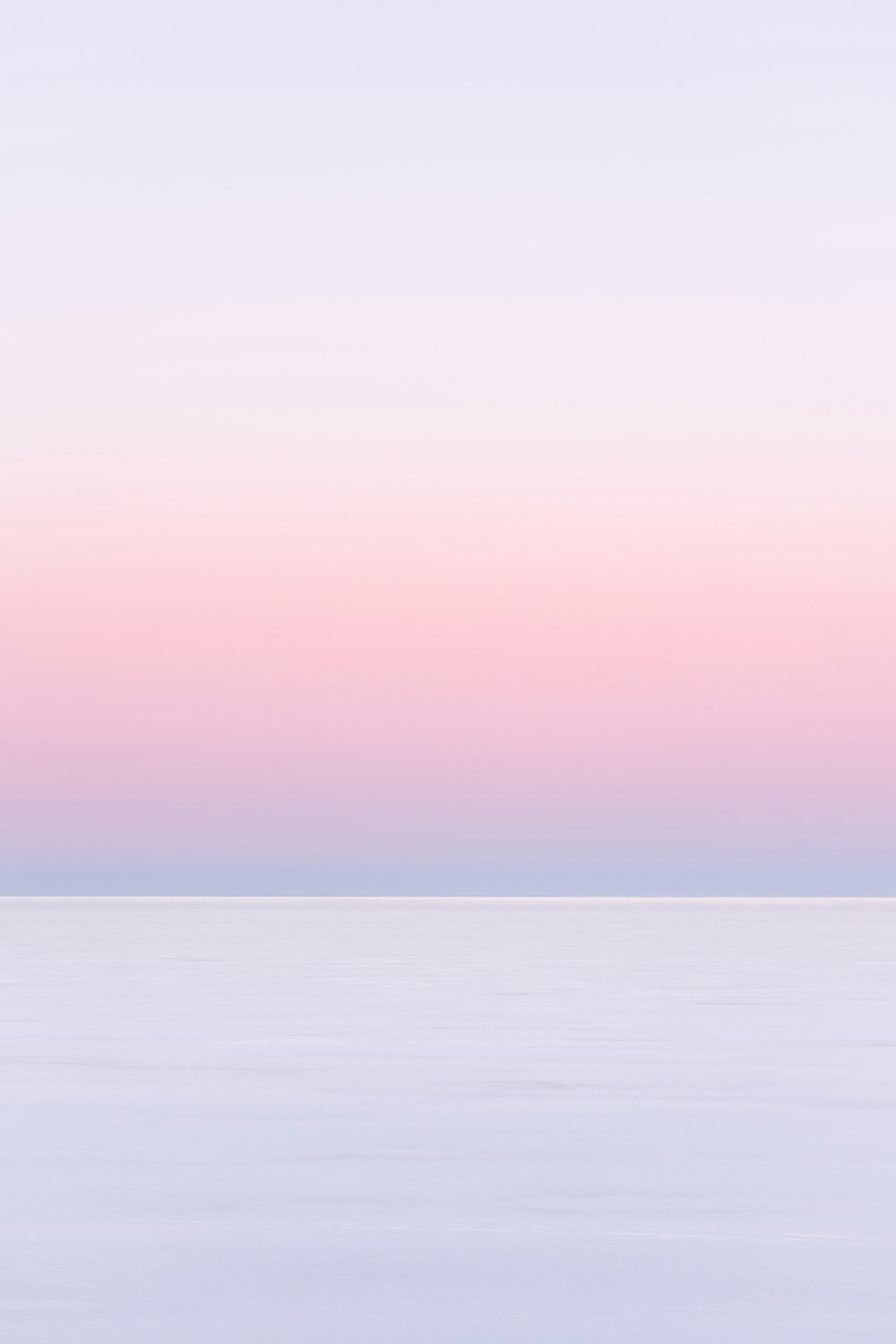 white and pink sky over the sea