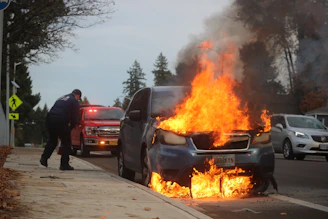 man in black jacket standing near fire