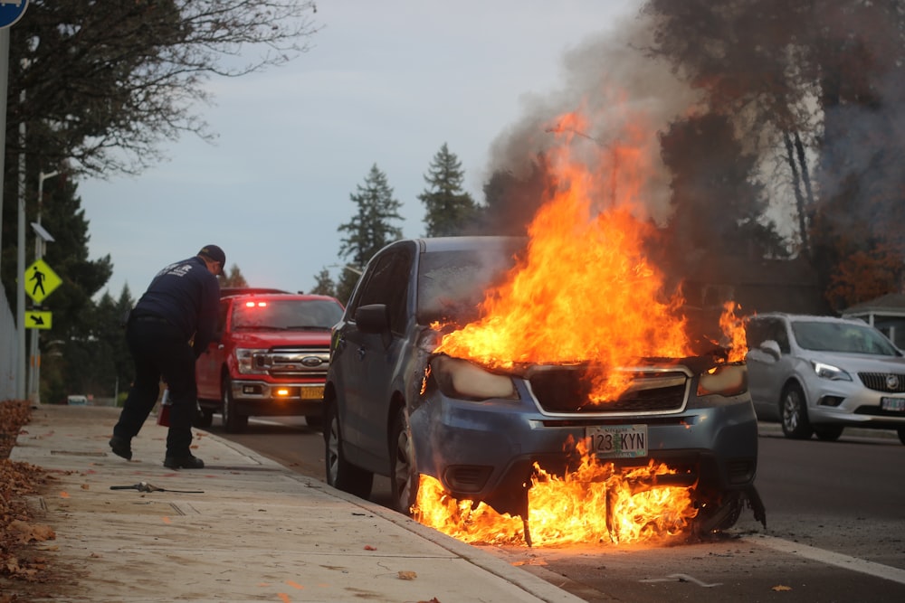 man in black jacket standing near fire