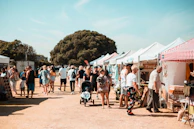 A lively scene of joyful people interacting with everythingie everythingie creations in a bustling market.