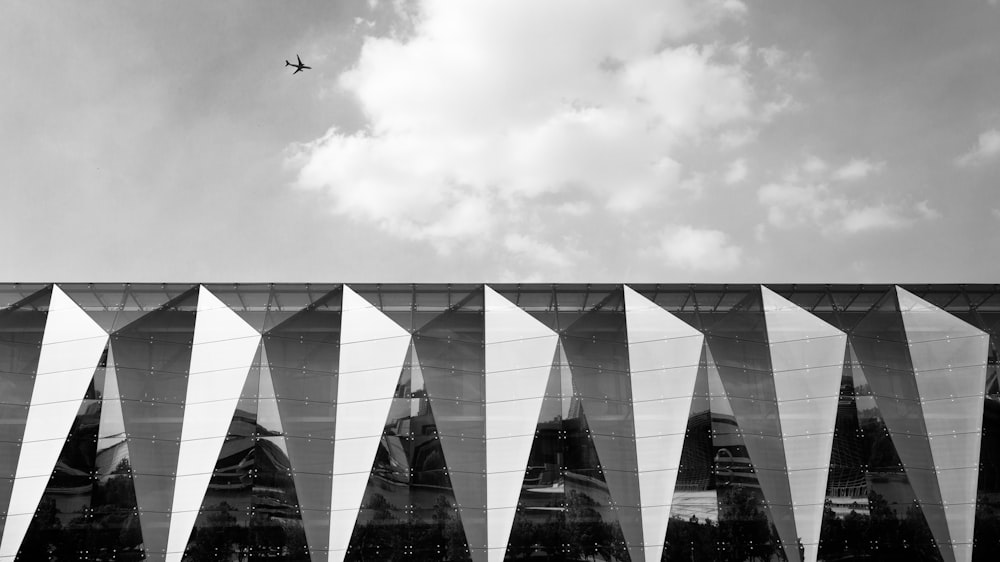 airplane flying over the building