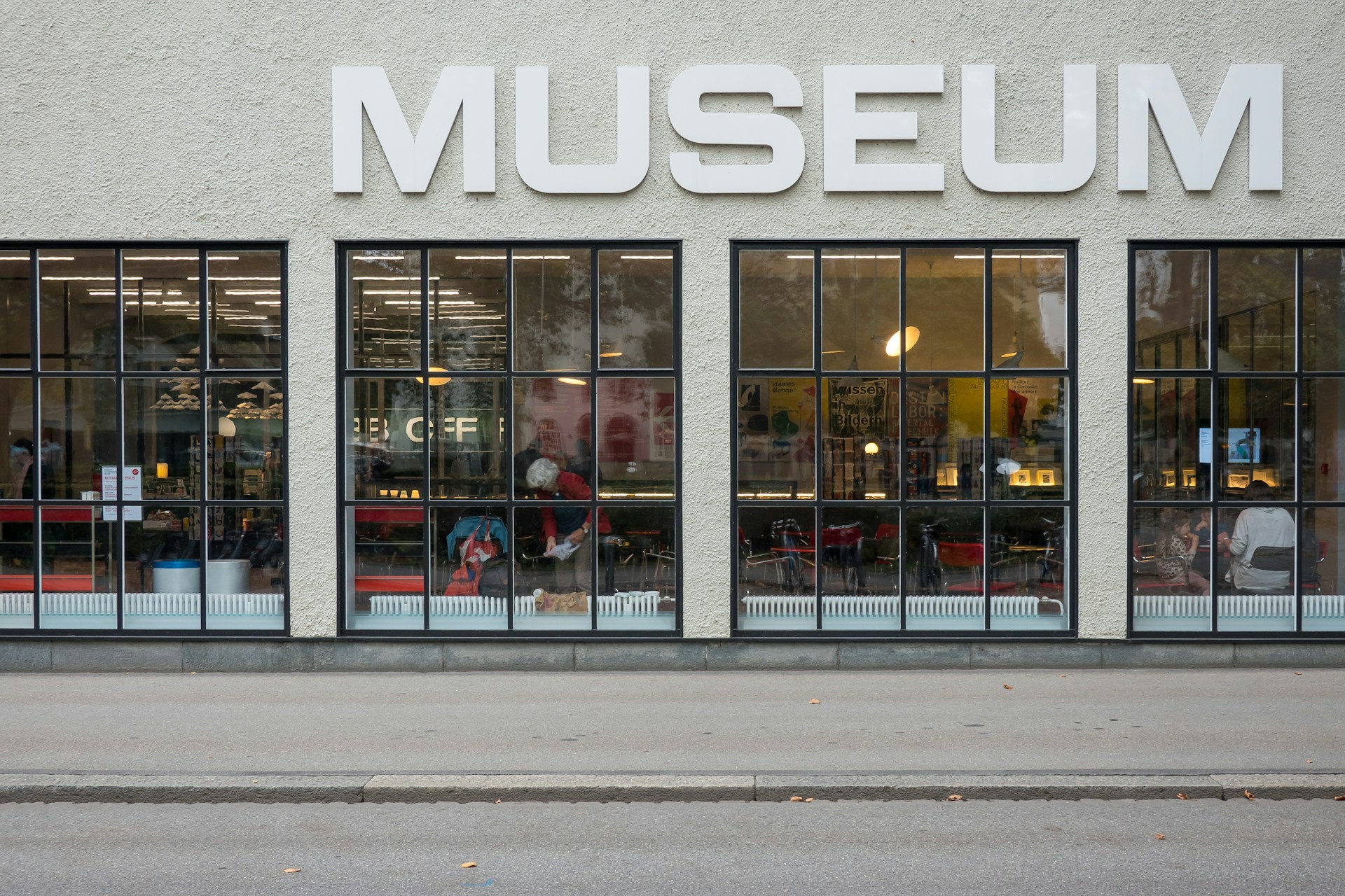 a museum store front with large windows on the side of the building