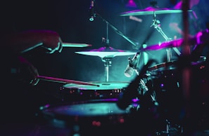 man playing drum set on stage