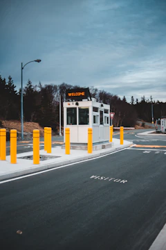 A friendly security guard welcoming visitors at a building entrance.