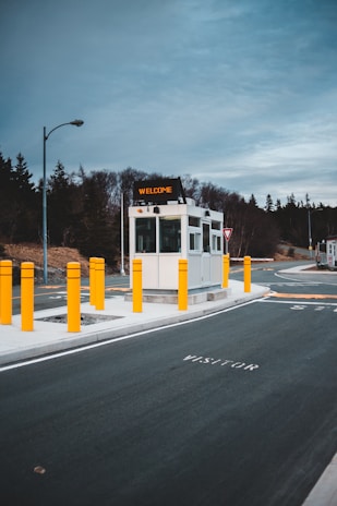 A friendly security guard welcoming visitors at a modern office entrance.