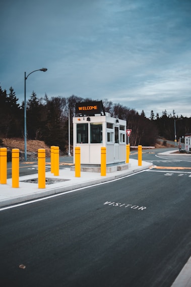 A friendly security guard welcoming visitors at a modern office entrance.