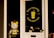 A storefront door with a cartoon-like cat figurine visible through the glass. The door features a circular logo with the phrase 'Life is too short for bad coffee' and an illustration of a coffee cup. The sign includes the establishment year, 2018.