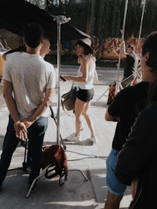 A group of students practicing camera work on a sunny outdoor set.