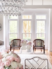 A bright, airy living room freshly cleaned with sunlight streaming through large windows.