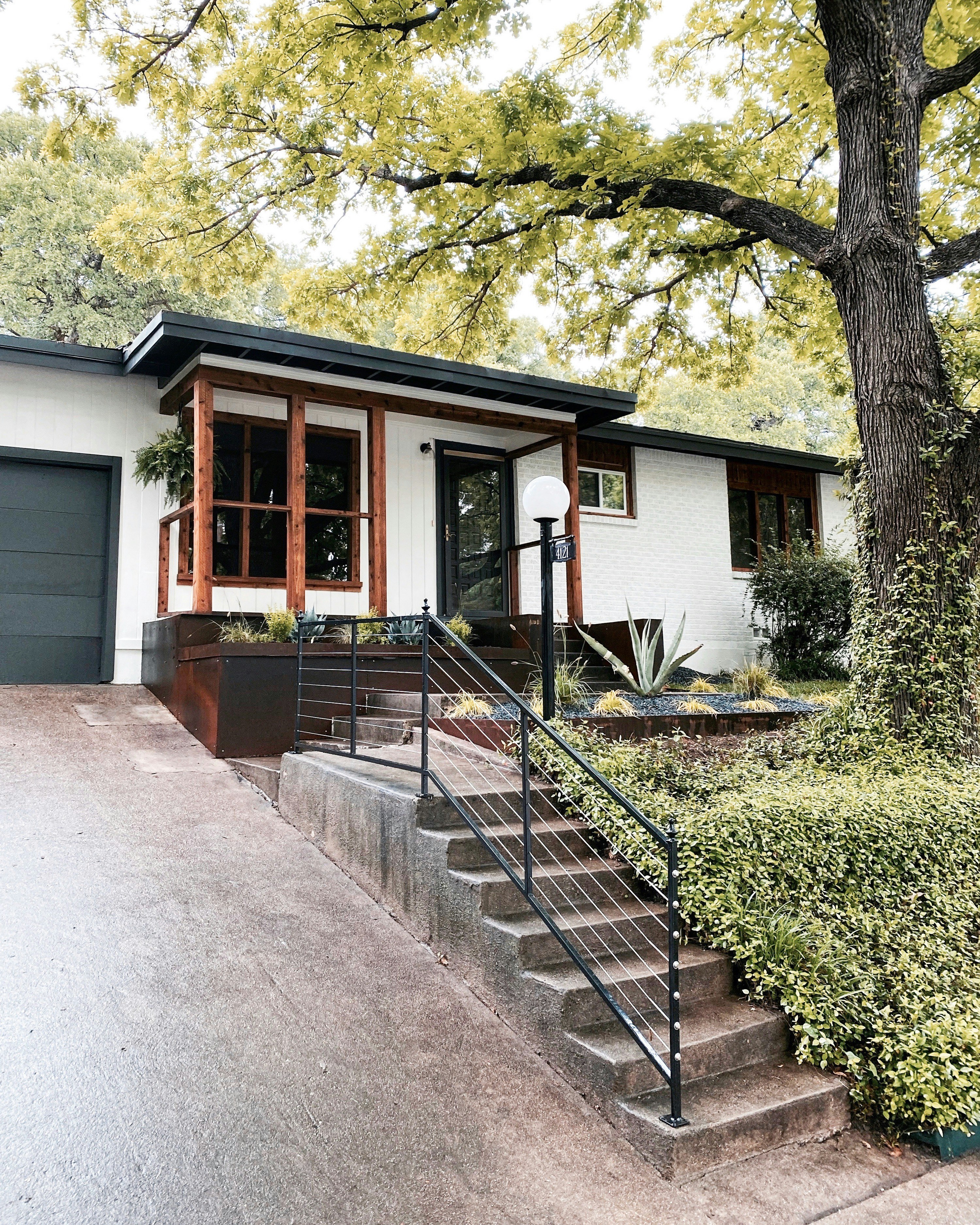 Modern house with wood accents and lush greenery