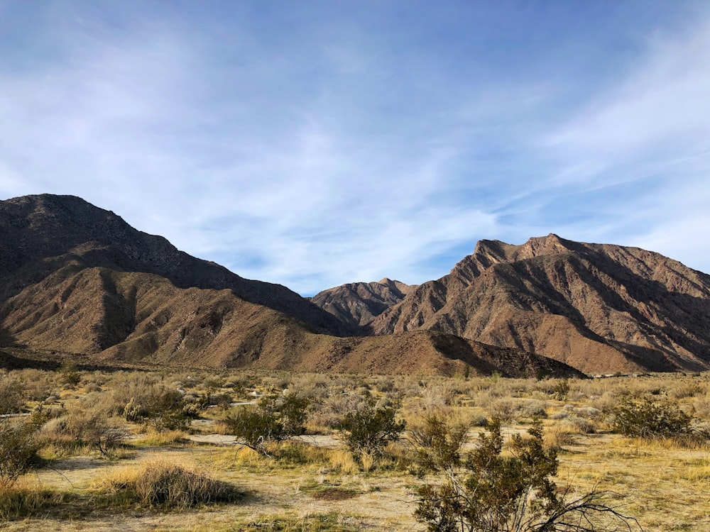 brown mountains under white clouds during daytime