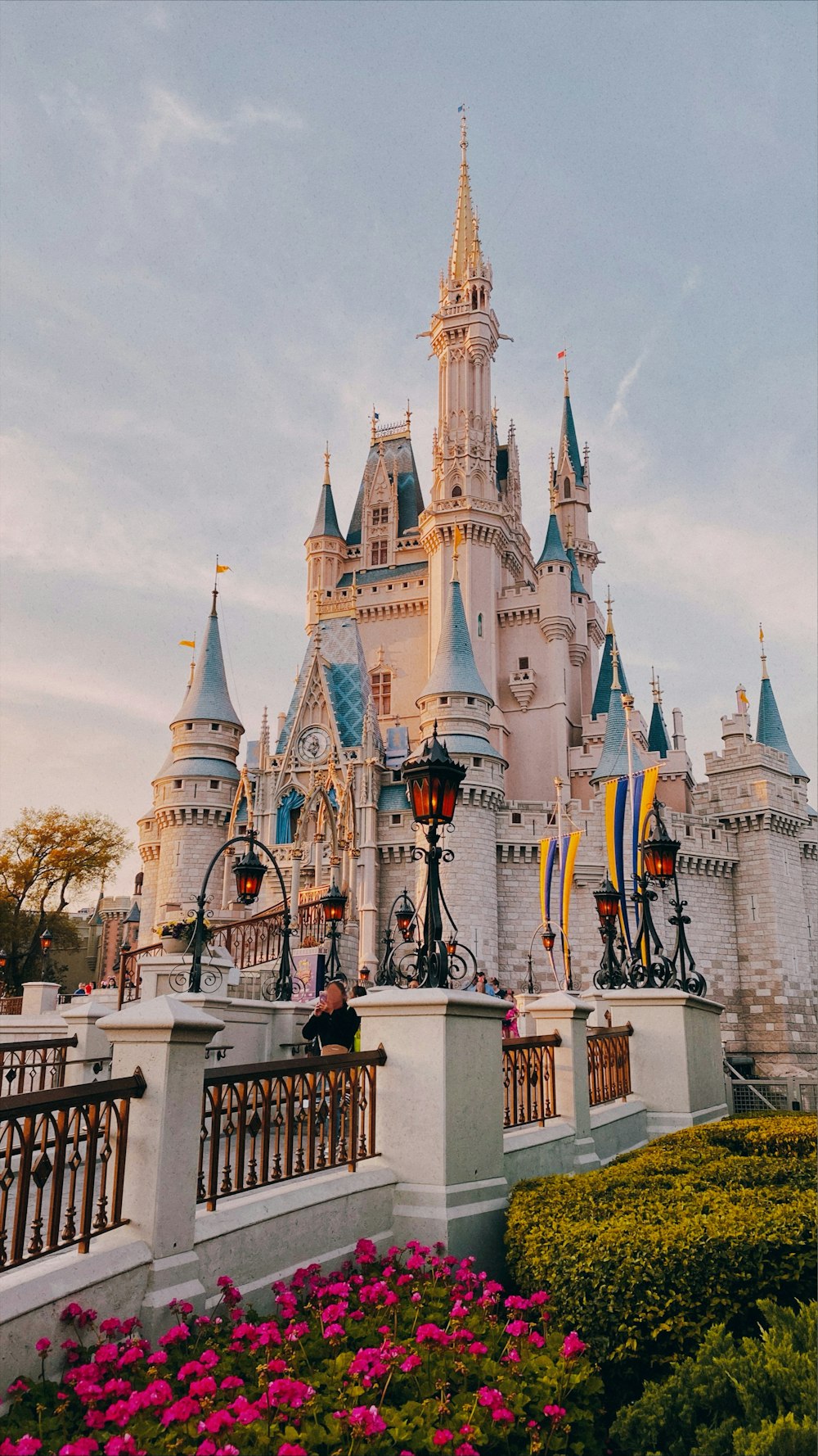 white and blue disney castle under blue sky during daytime