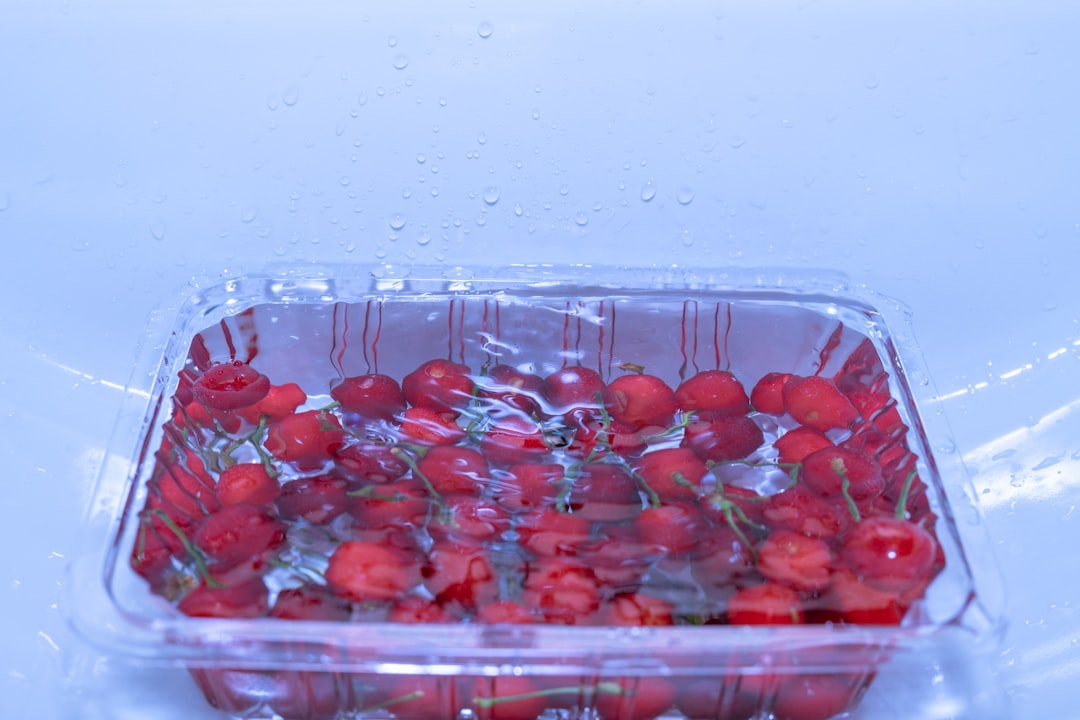 red round fruits in clear plastic container