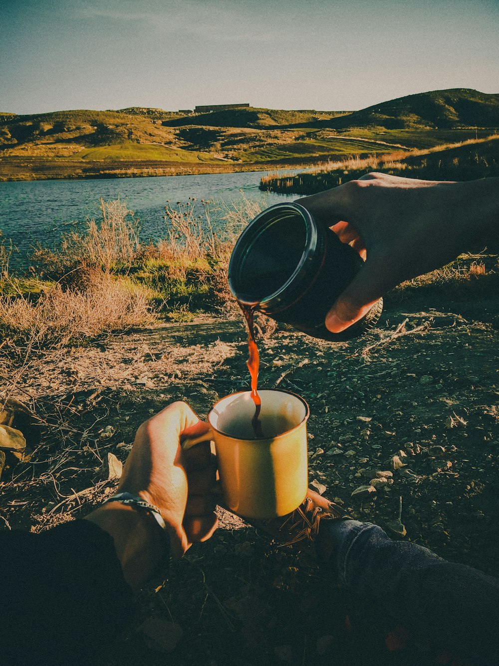 person holding white ceramic mug