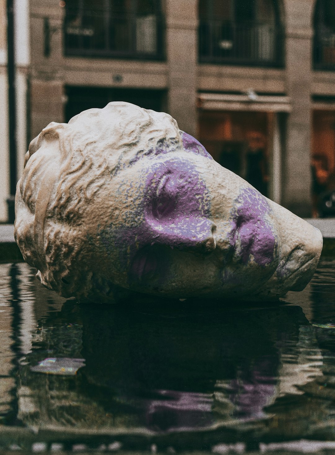 pink animal head statue on water