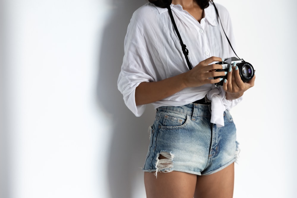 woman in white button up shirt and blue denim shorts