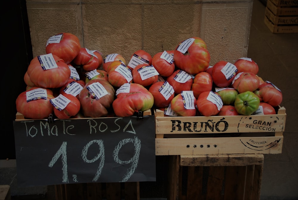 red and green apple fruits on brown wooden crate