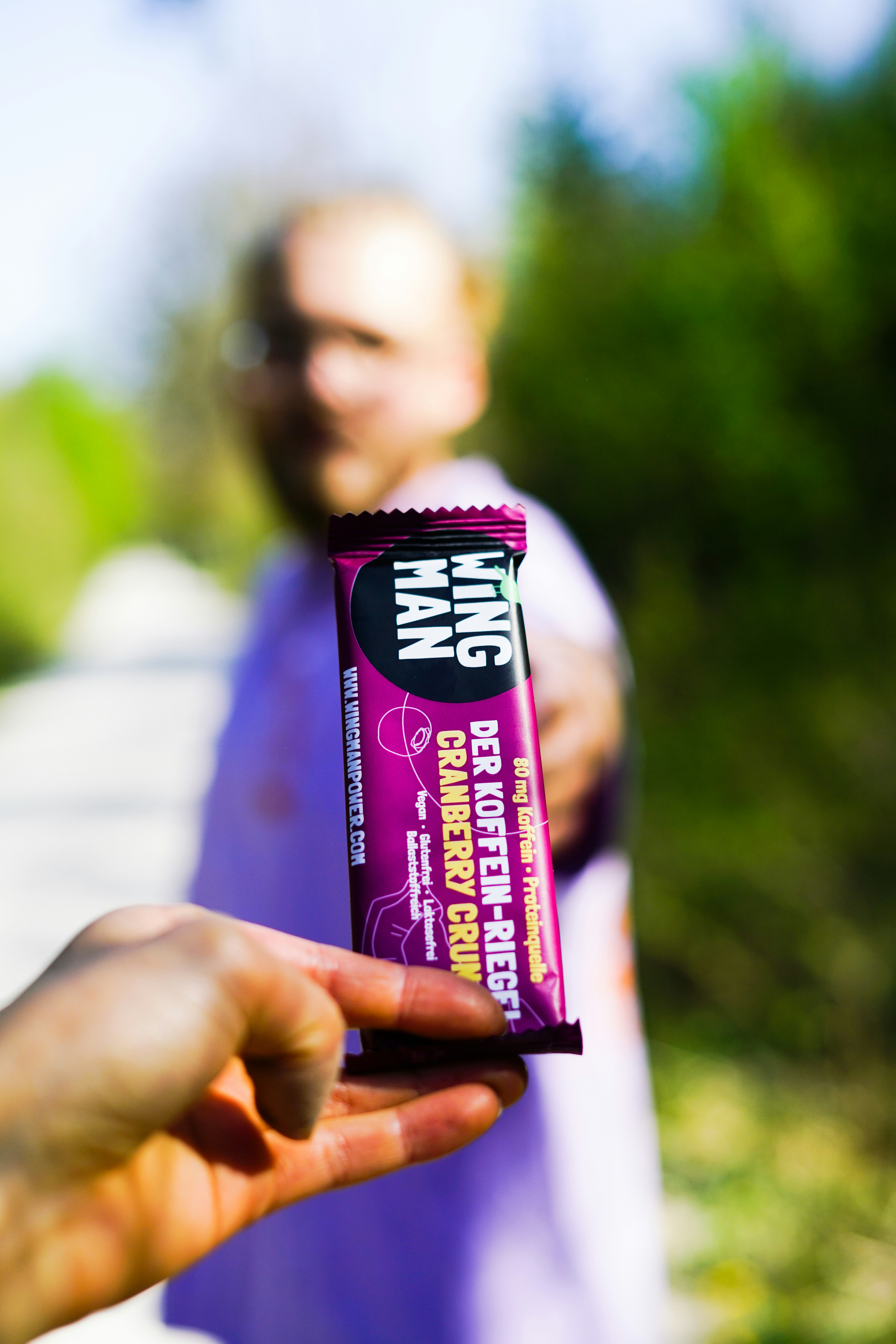person holding UNKs chocolate bar
