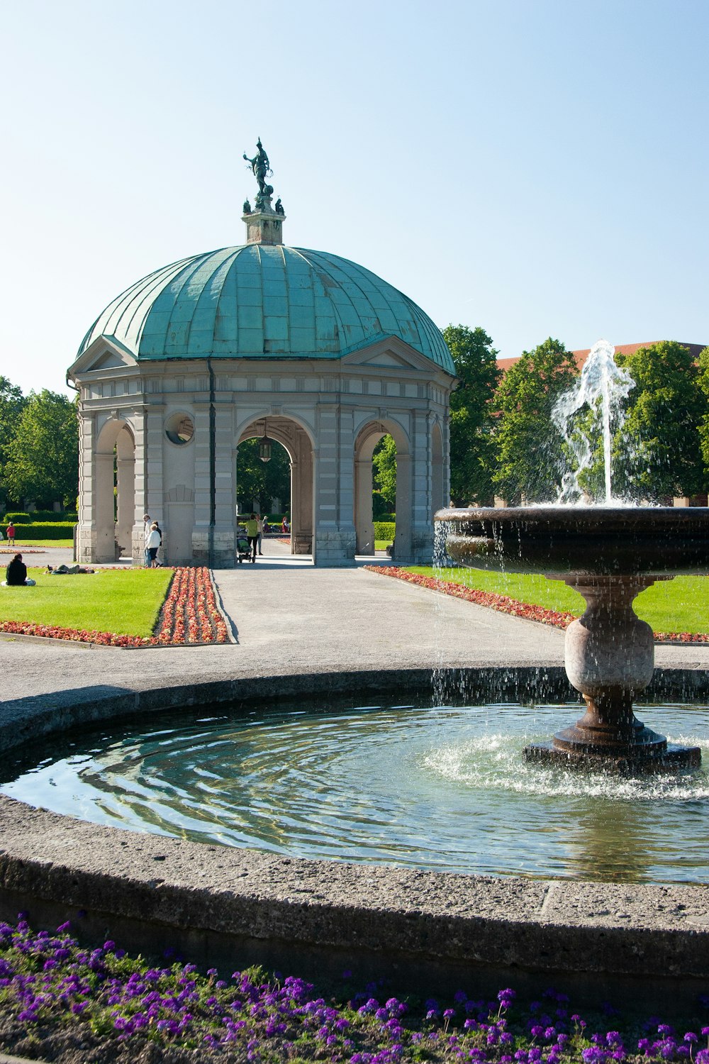 water fountain in front of white and green dome building