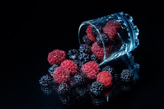 red round fruits in clear glass jar