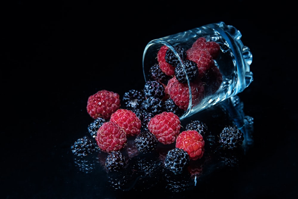 red round fruits in clear glass jar