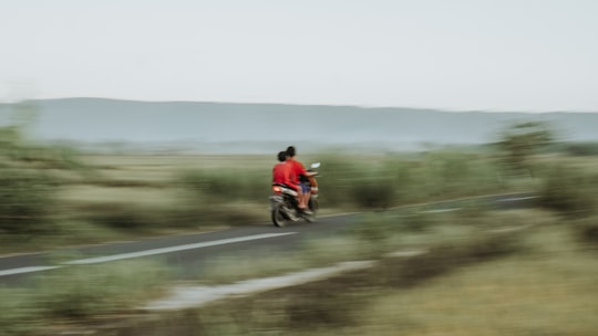 man in red jacket riding motorcycle on road during daytime in Bantul Indonesia