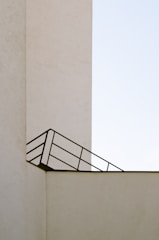 Minimalist architectural blueprint on a clean black and cyan background.