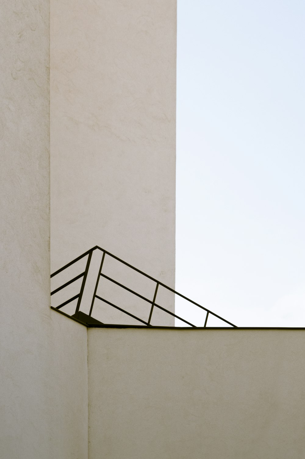 black metal staircase on white wall