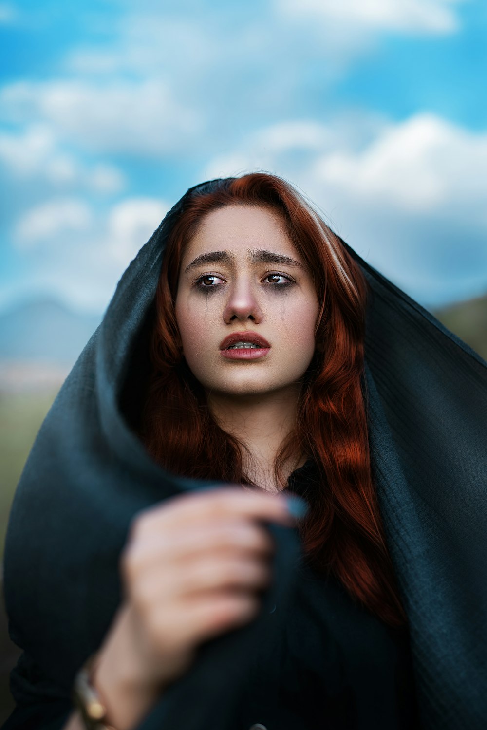 woman in gray hoodie under blue sky during daytime