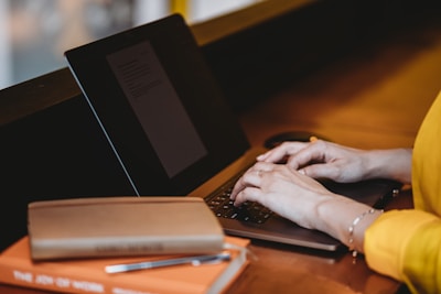 person using black laptop computer