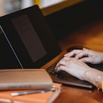 person using black laptop computer