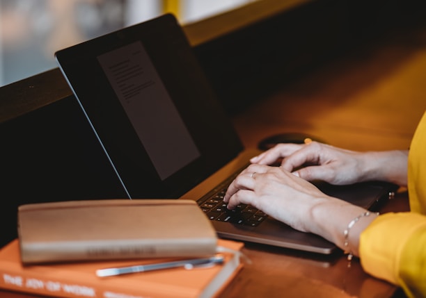 person using black laptop computer