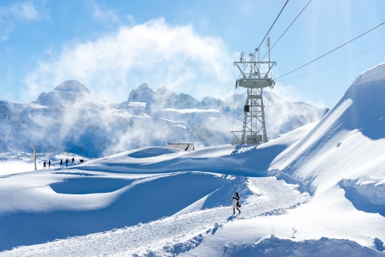 white snow covered mountain under blue sky during daytime in Obertraun Austria