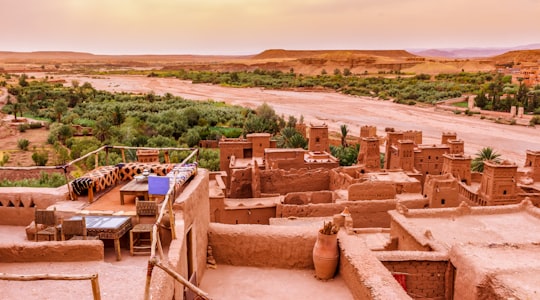 brown concrete blocks on brown sand during daytime in Ouarzazate Morocco