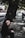 An elderly man sitting on a park bench, reflecting.
