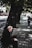 An elderly man sitting on a park bench, reflecting.