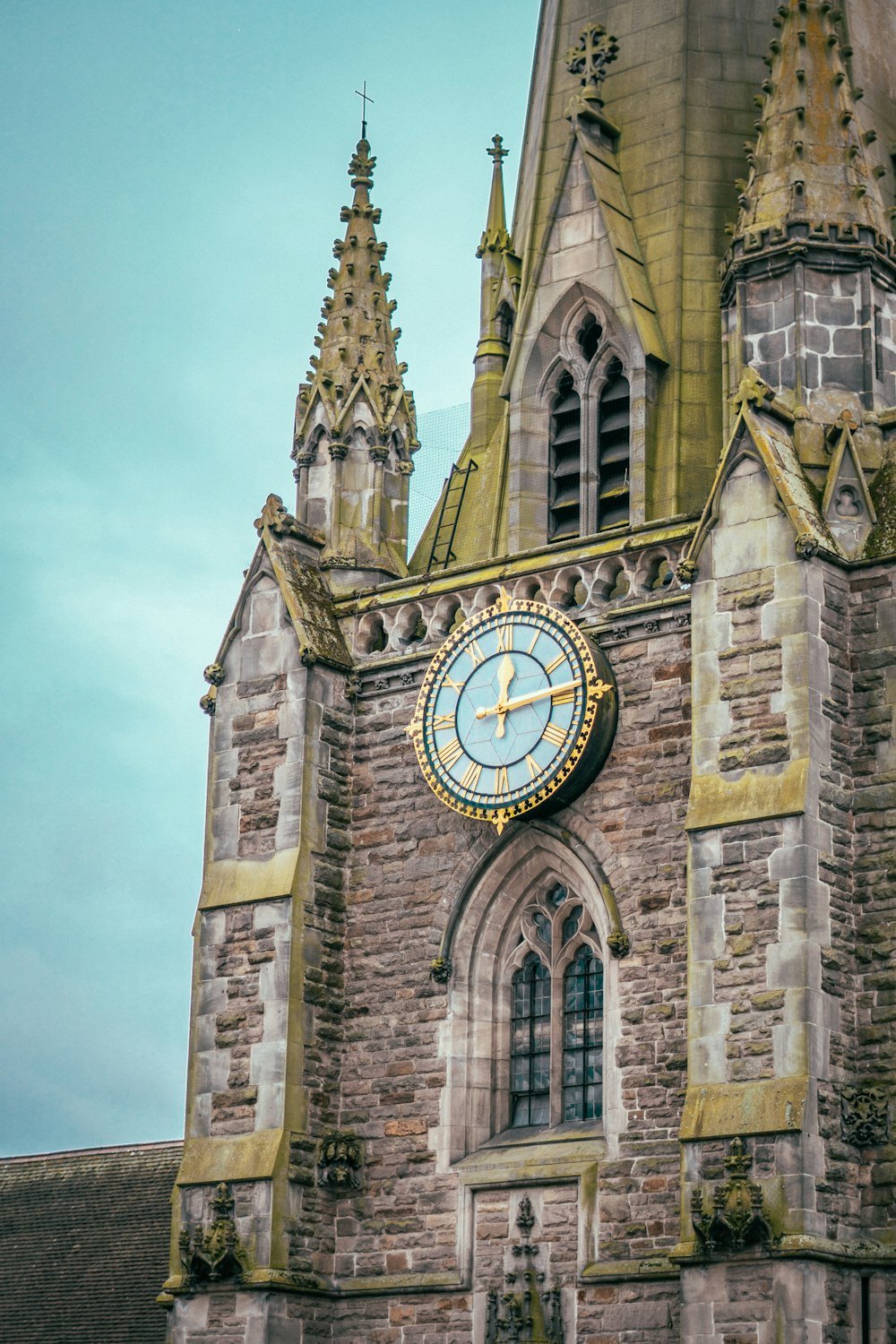 brown concrete building with analog clock