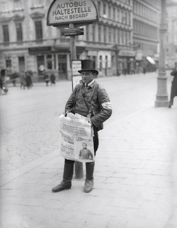 A vibrant street scene showing a vendor selling newspapers early in the morning.