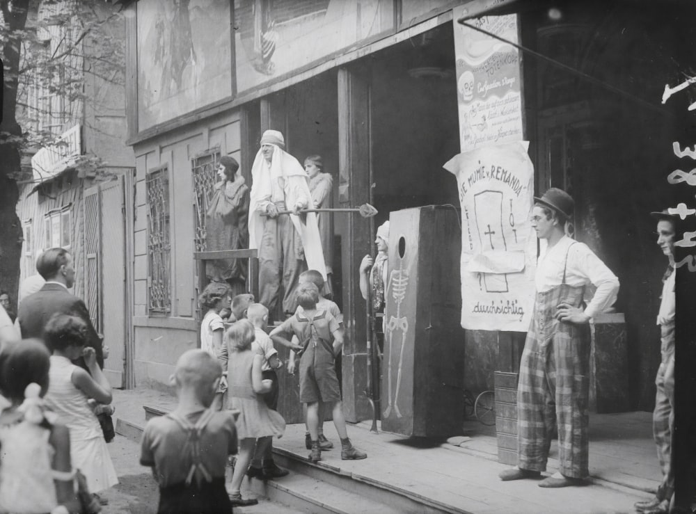 grayscale photo of people sitting on bench