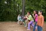 group of children standing on brown soil during daytime