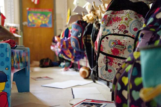 black yellow and red backpack on white table