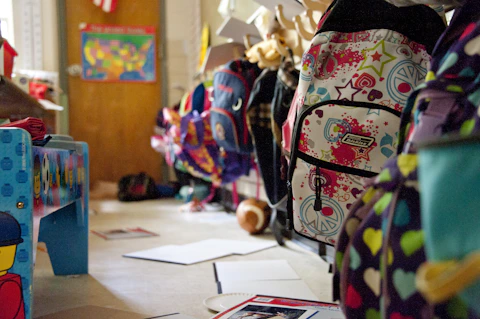 row of elementary school backpacks in a classroom