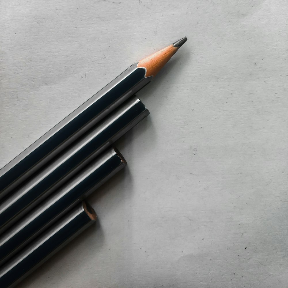 blue and brown pencil on white surface